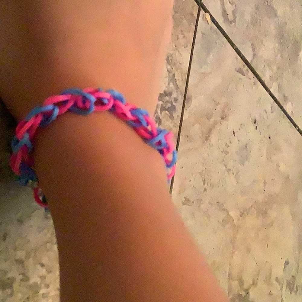 A bracelet that is pink and blue and 1  bracelet equals 2$